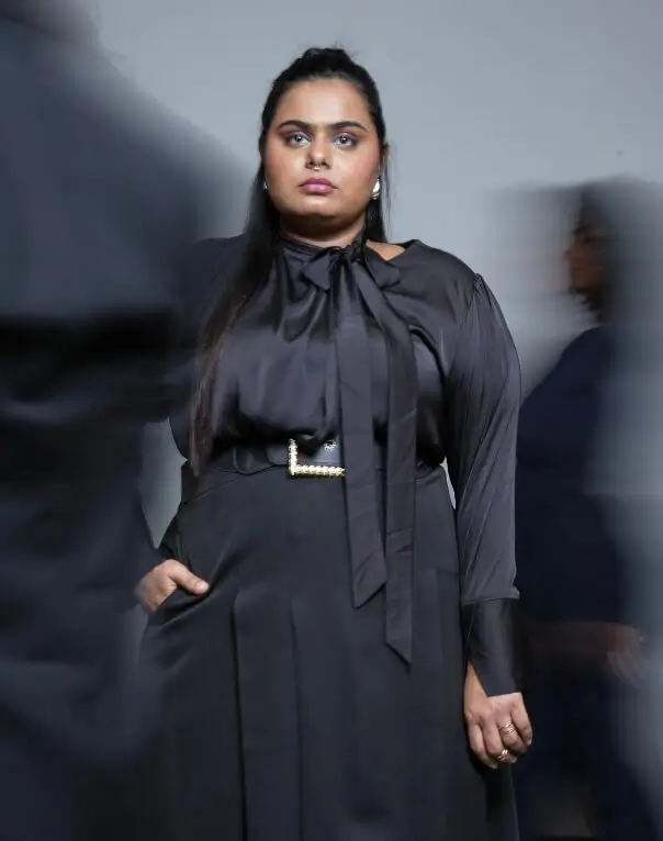 Woman in black dress at community shoot